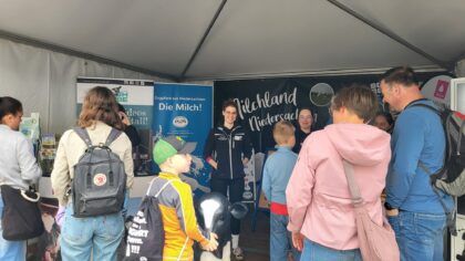 Familien am Milchland-Stand in einem Veranstaltungszelt